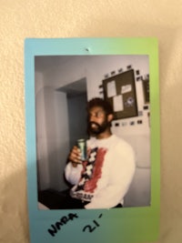 a picture of a man holding a polaroid